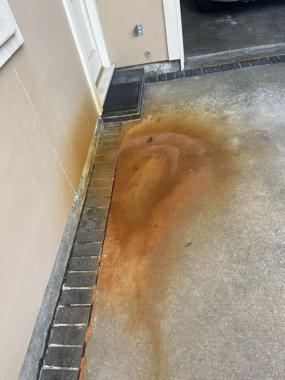 Orange rust staining on concrete before treatment