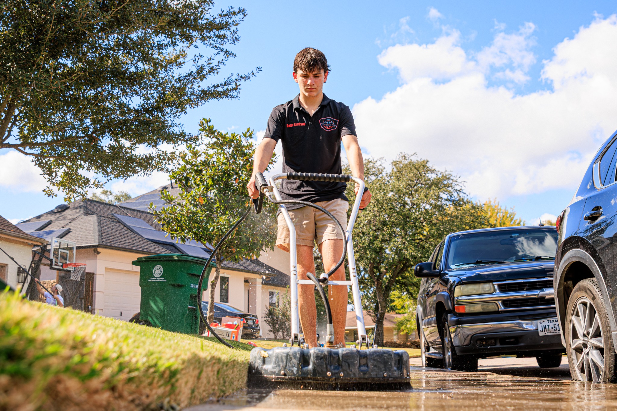 Bellaire Pro Wash technician surface-cleaning a Houston driveway