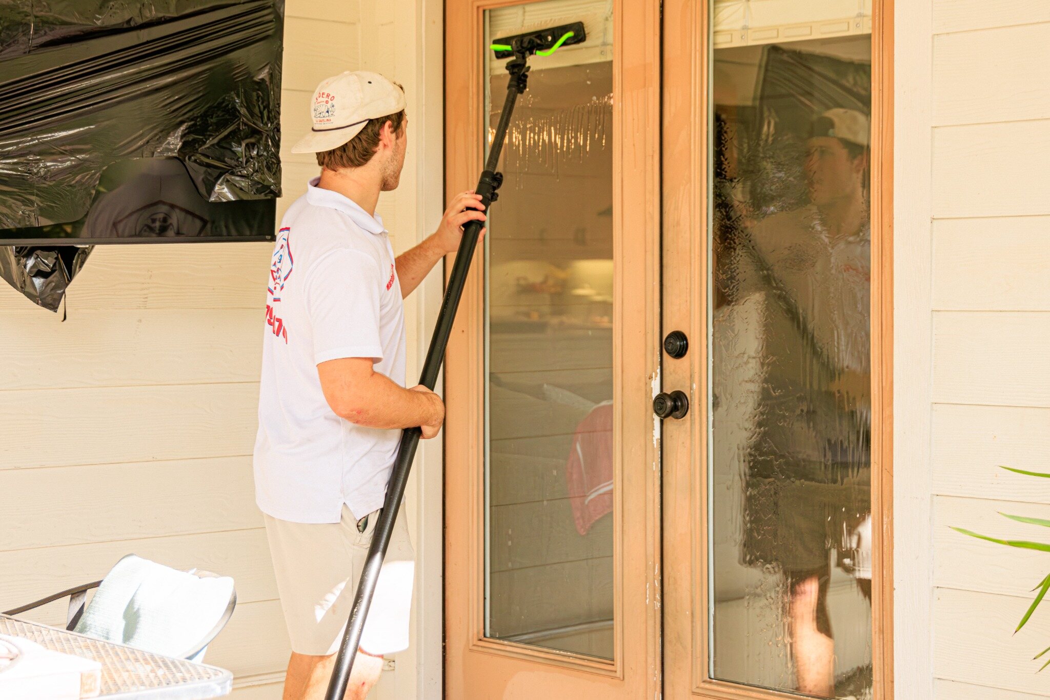 Bellaire Pro Wash technician detailing residential glass